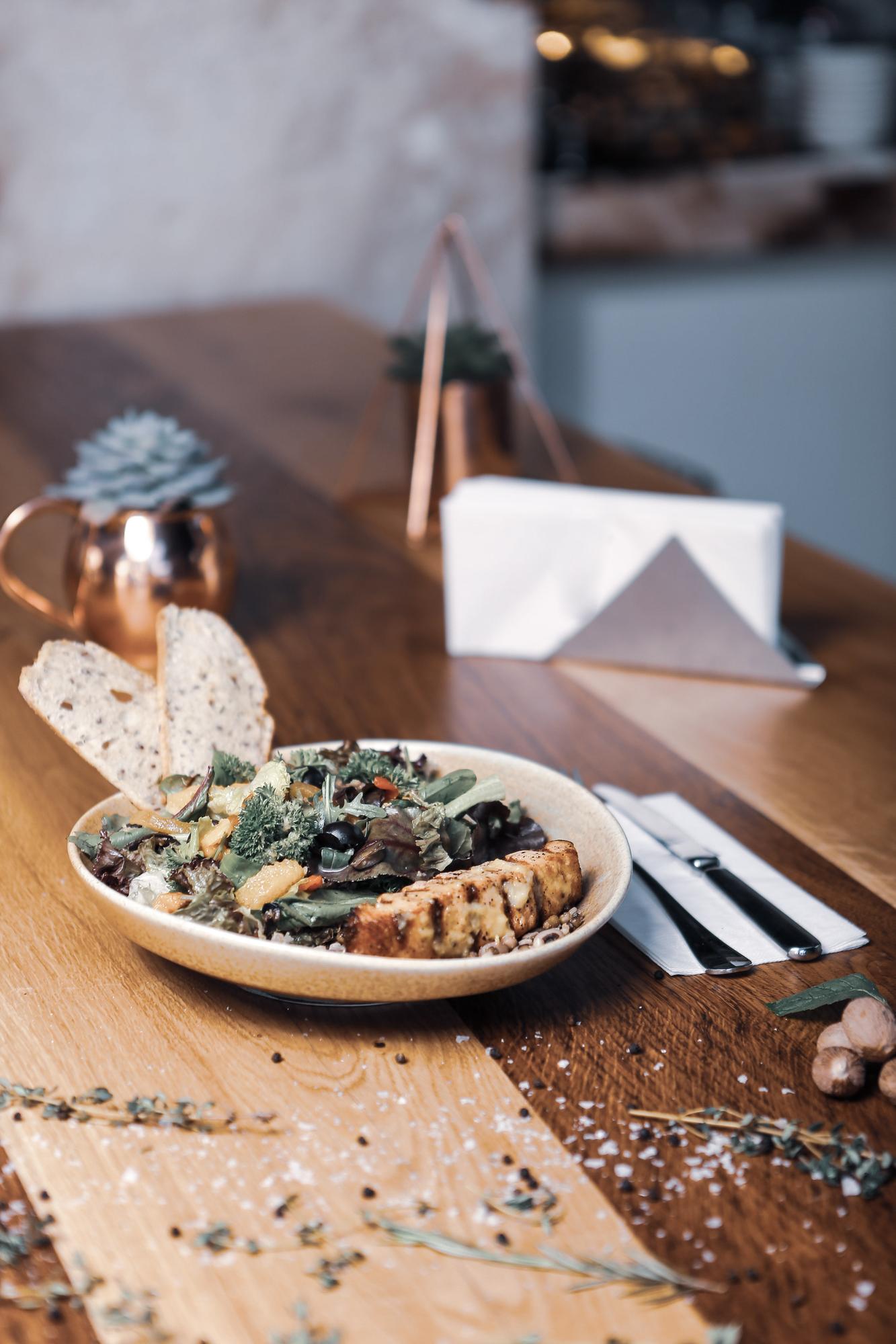 Artisanal plated dish with herbs on wooden table